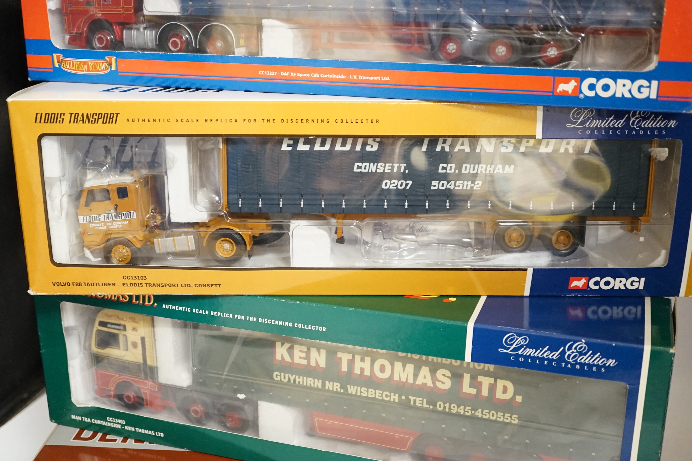 Four boxed Corgi 1:50 scale articulated trucks; a DAF XF Space Cab Curtainside lorry (CC13227), a MAN TGA curtainside lorry (CC13403), a Scania Topline with Fridge Trailer (CC12929) and a Volvo F88 Tautliner curtainside